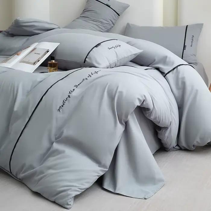 Nouvel ensemble de draps et de draps-housses 4 pièces en coton lavé doux pour la peau, couleur unie, avec ruban brodé et double bordure